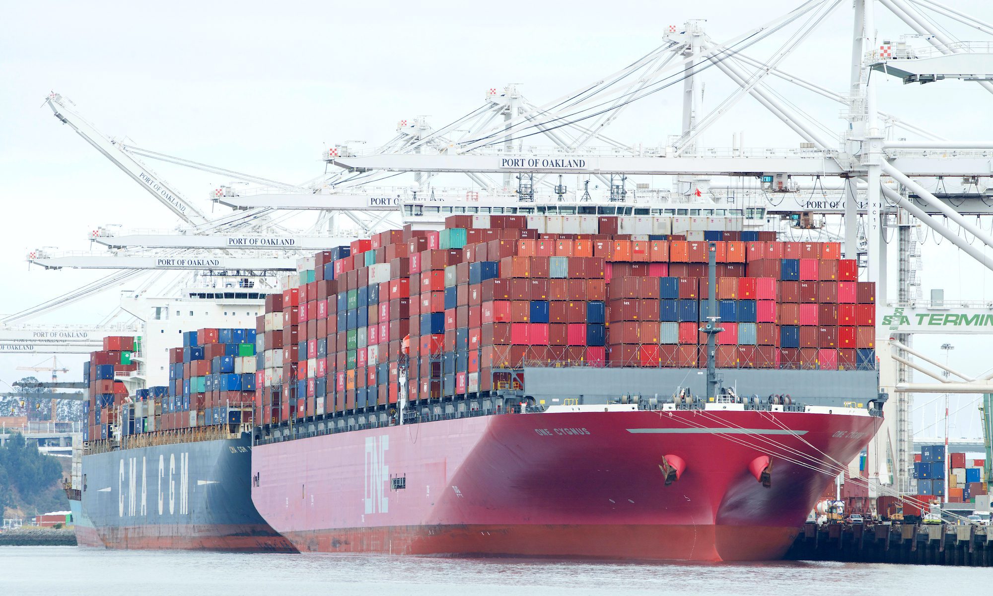 cargo ships loading at port of oakland